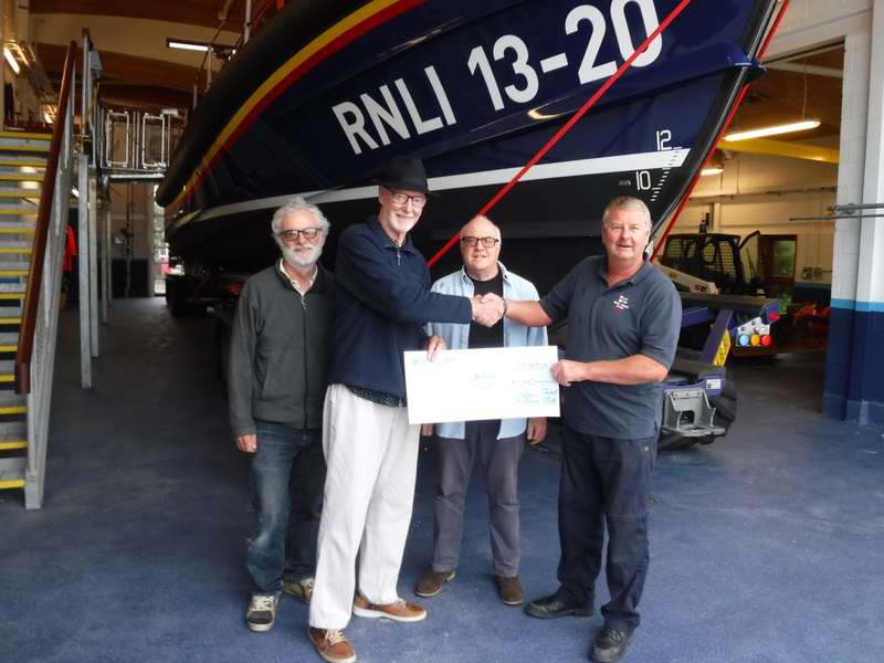 Coxswain, Martin Rudwick, being presented with the cheque by Julian